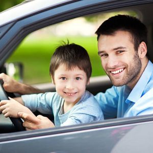 Father and son sitting in a car