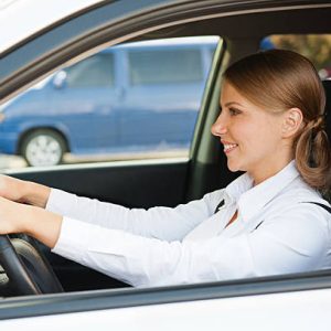 smiley and prosperous businesswoman driving the car